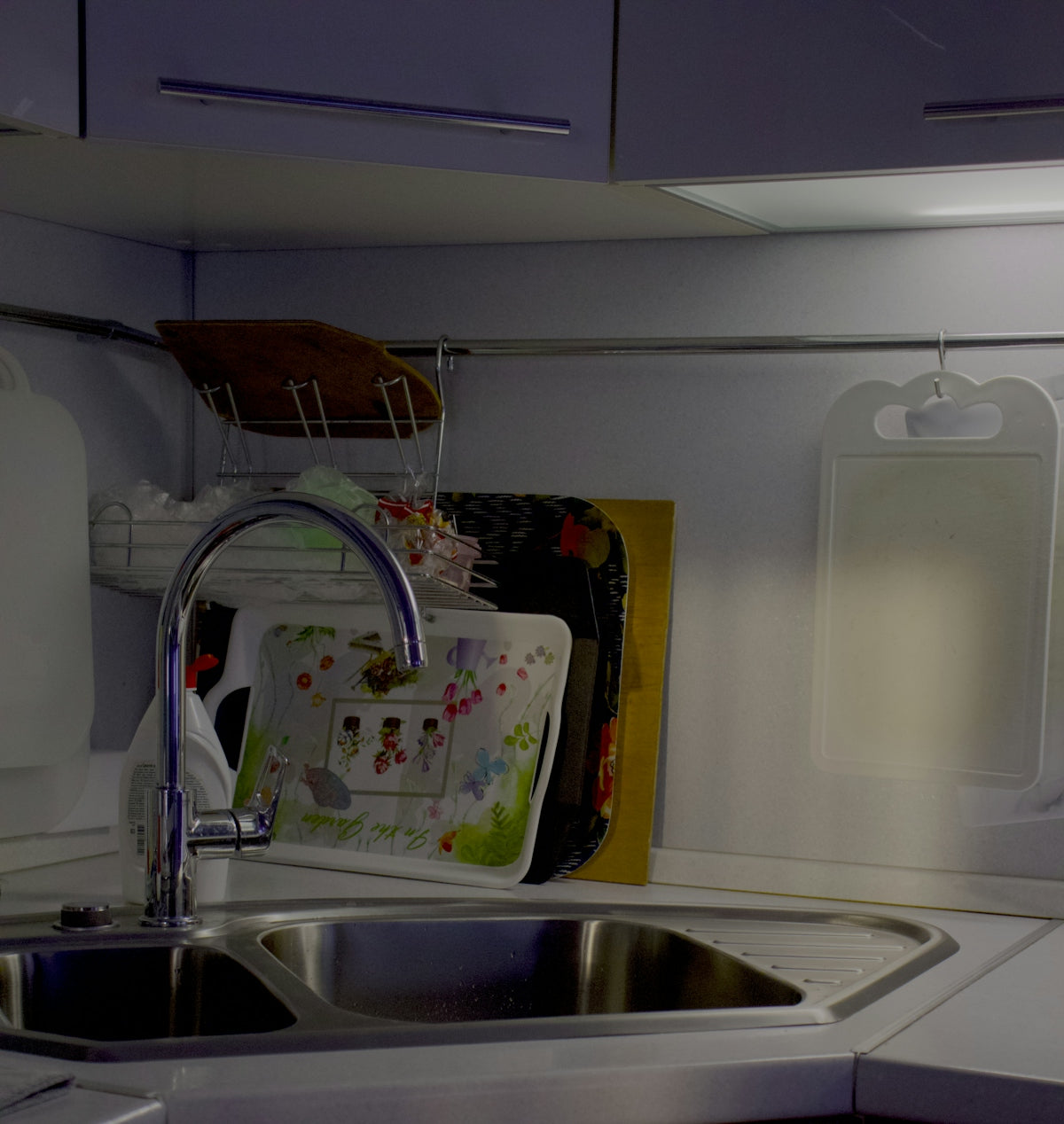 A kitchen with a sink and a microwave
