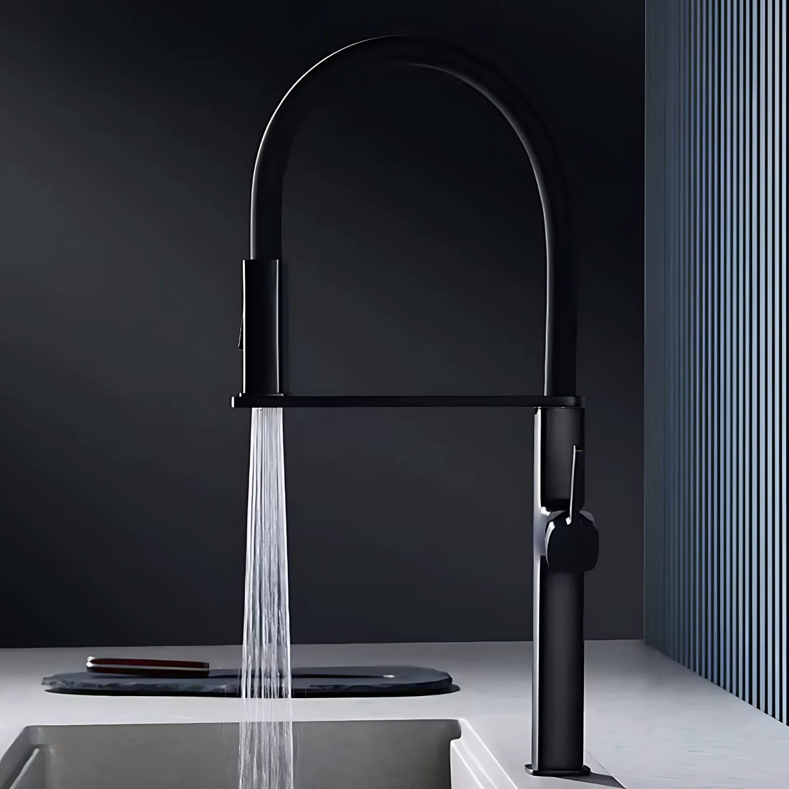 Black premium faucet with water flowing into a sink against a dark background