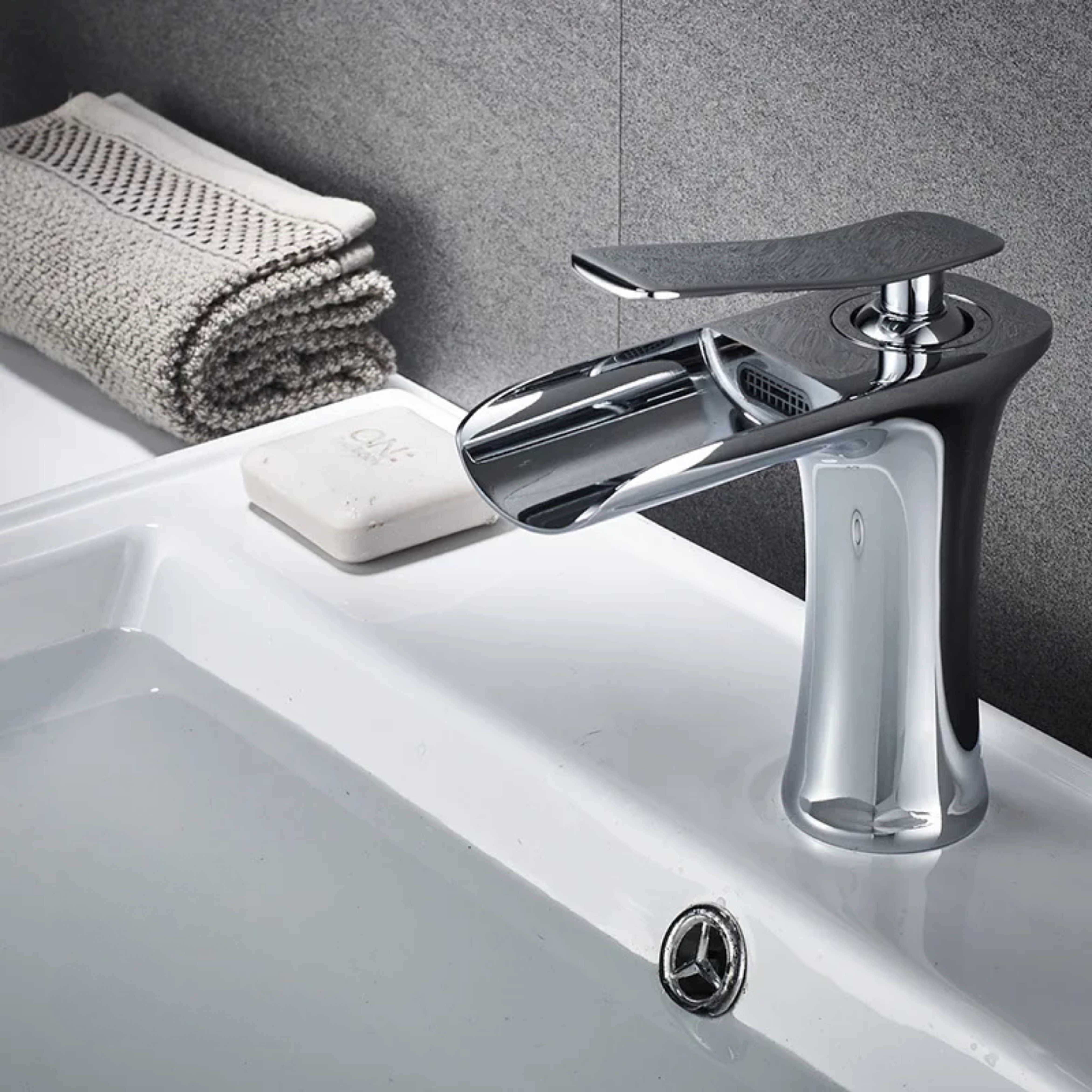 Chrome kitchen faucet attached to a sink, featuring a smooth, shiny finish for a modern and elegant look.