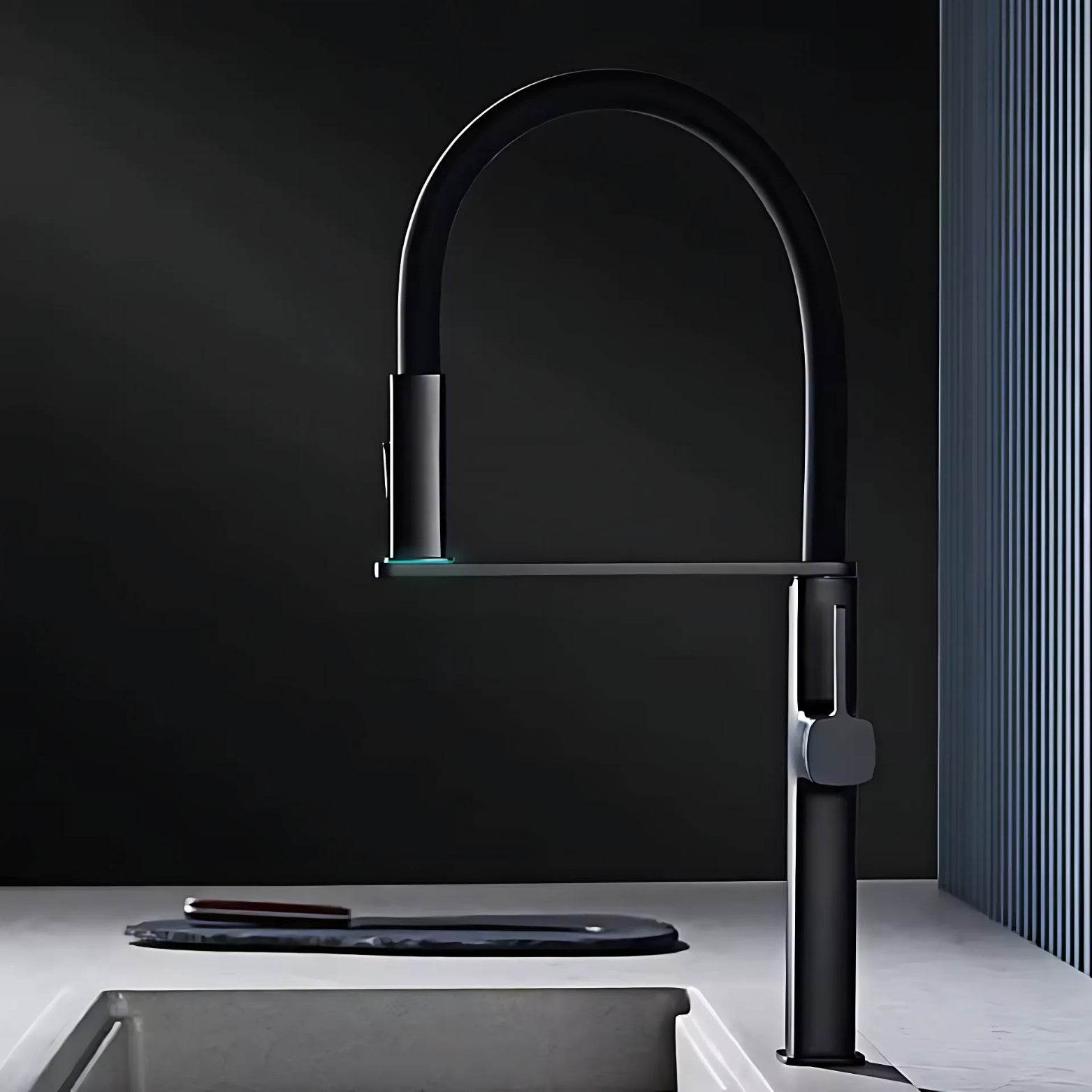 Modern premium black kitchen faucet against a dark wall with a light gray sink.