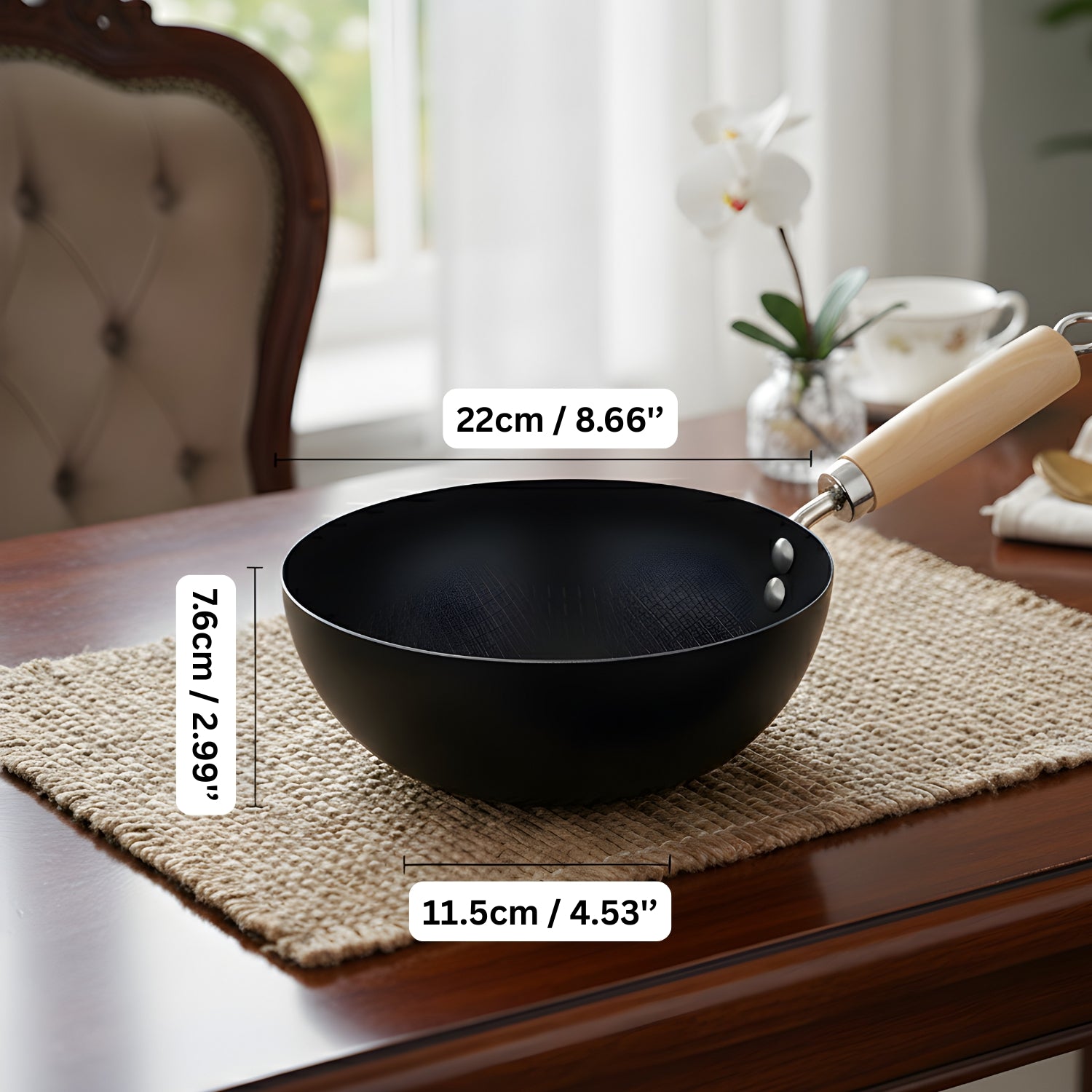Black wok with wooden handle on a table with measurements displayed