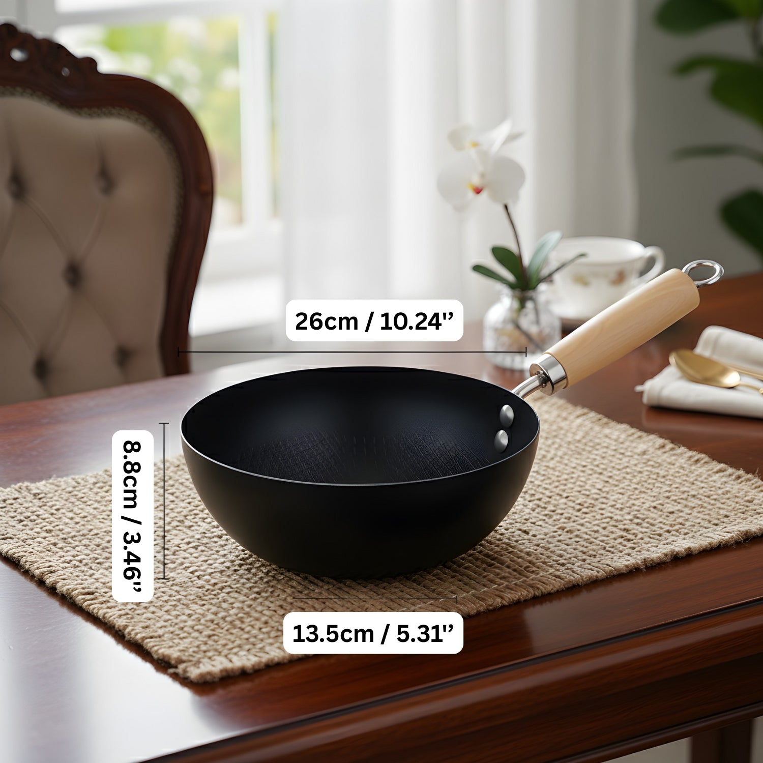 Black wok with wooden handle on a table with measurements displayed