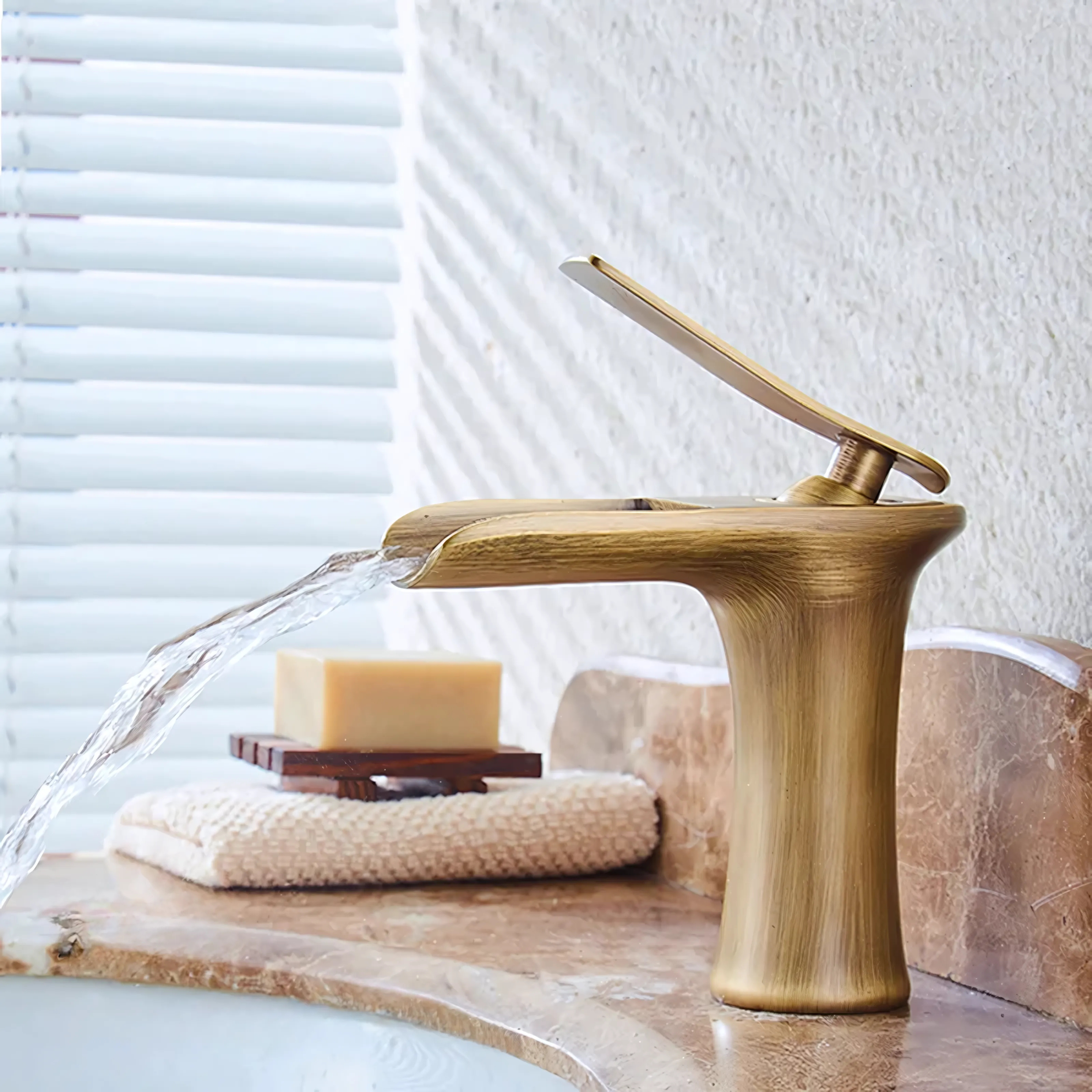 Antique kitchen faucet attached to a sink, featuring a smooth, shiny finish for a modern and elegant look.