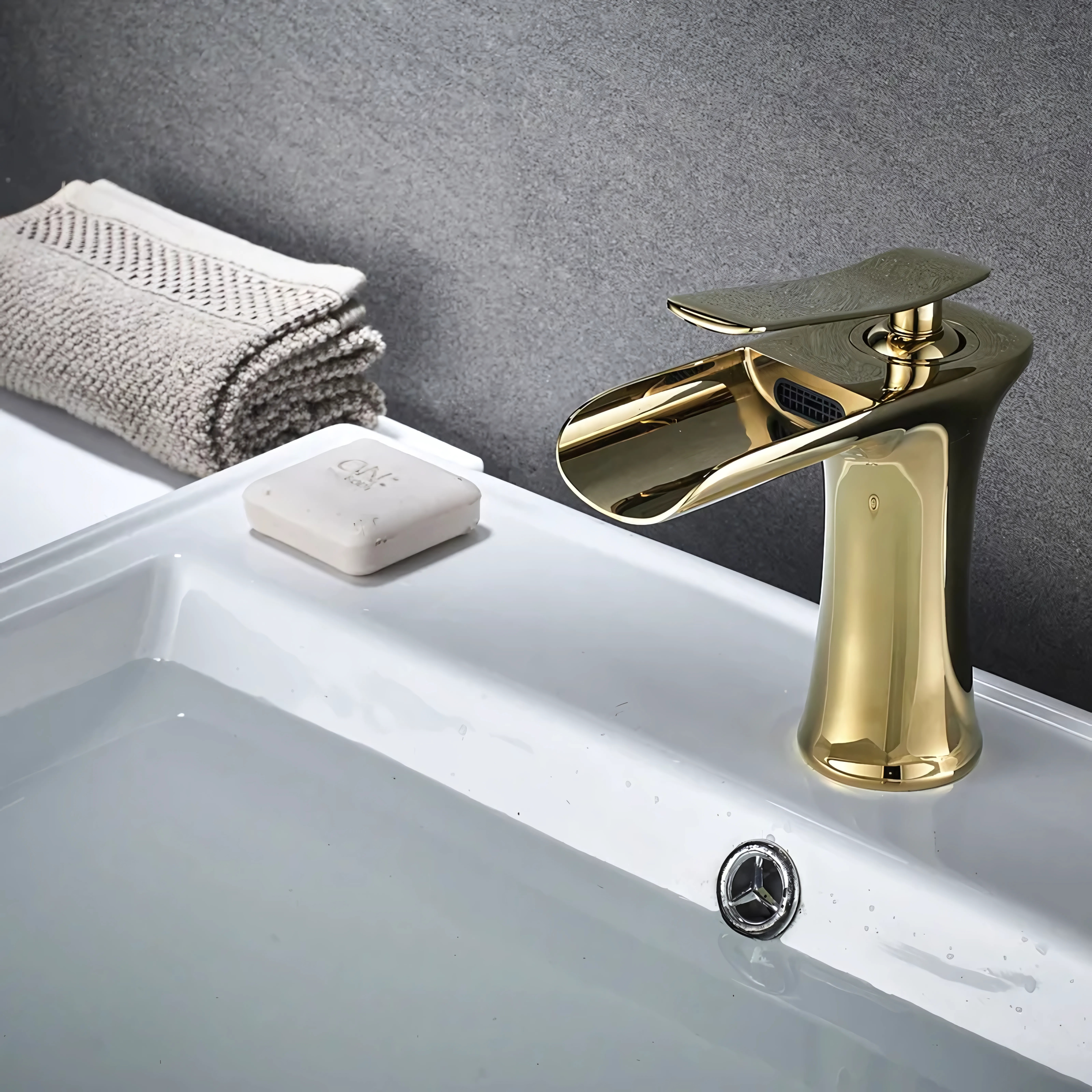 Gold kitchen faucet attached to a sink, featuring a smooth, shiny finish for a modern and elegant look.